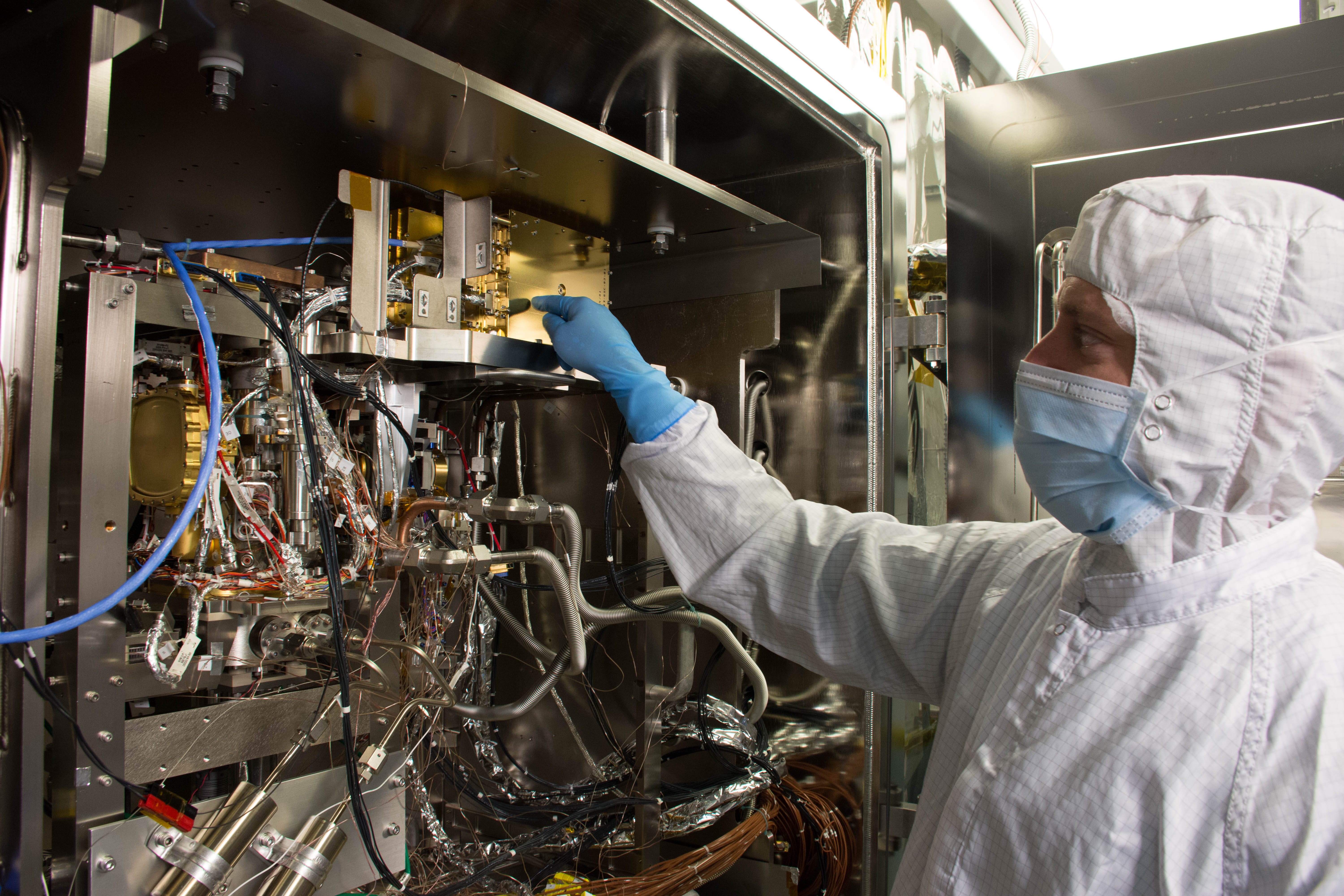 Precise assembly - a NASA technician examines the MOMA instrument during a thermal vacuum test. (Photo: NASA)